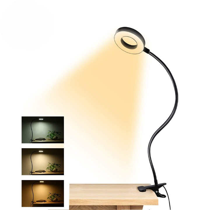 SUR un fond blanc on voir une lampe de bureau noire flexible, accrochée à une table. en bas à gauche on voit 3 carré noir avec les différentes couleur d'ampoule, une blanche , une jaune et une orange.